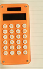Orange calculator on top of lined paper.